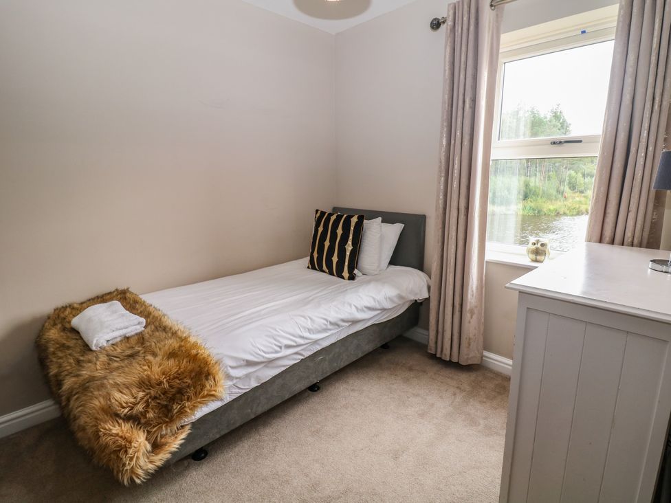 A bedroom with a bed and window at Hardwick in Darley Moor near Two Dales
