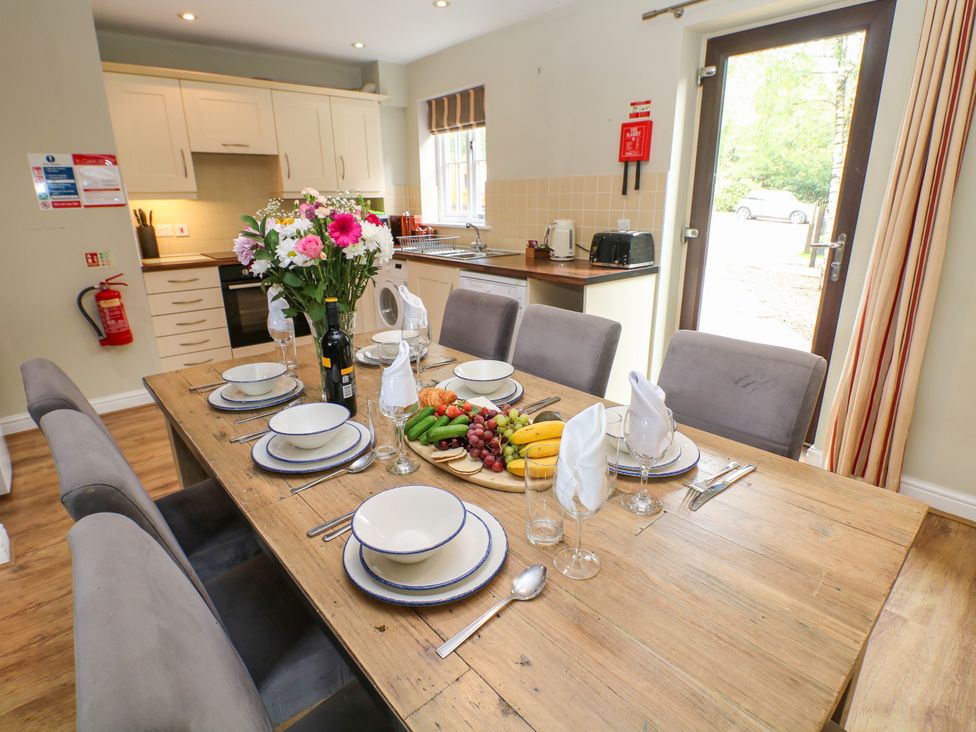 A dining room with a table set for a meal at Hartington Darley Moor near Two Dales