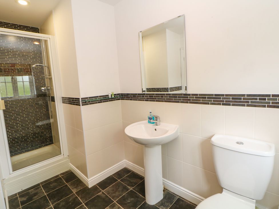 A bathroom with a shower, sink, and toilet at Hartington, Darley Moor near Two Dales