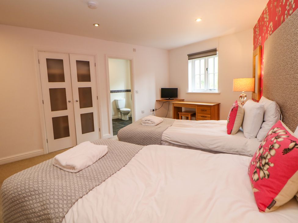 A bedroom with two beds and a television at Hartington Darley Moor near Two Dales