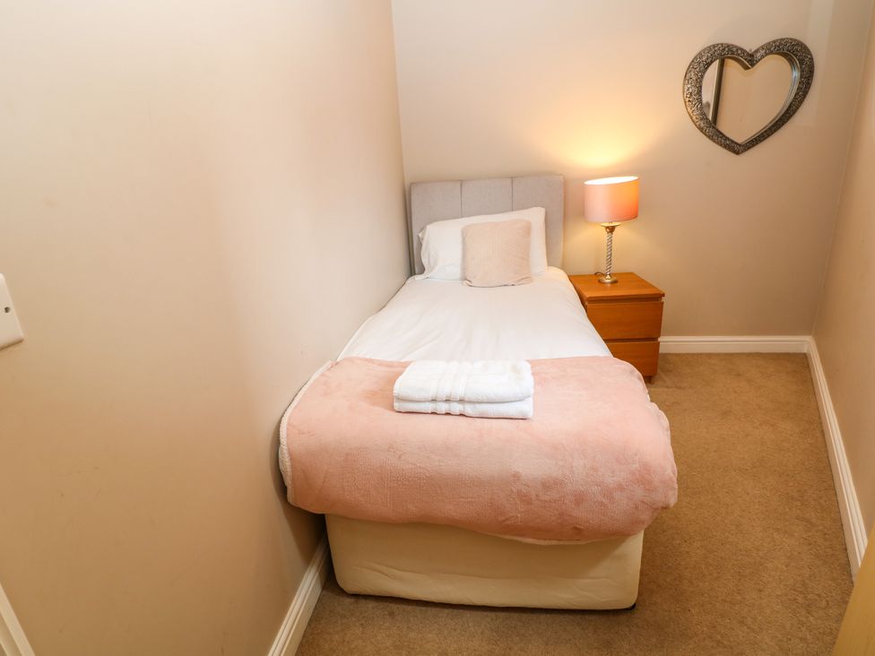 A bedroom with a single bed and bedside table at Hartington in Darley Moor near Two Dales