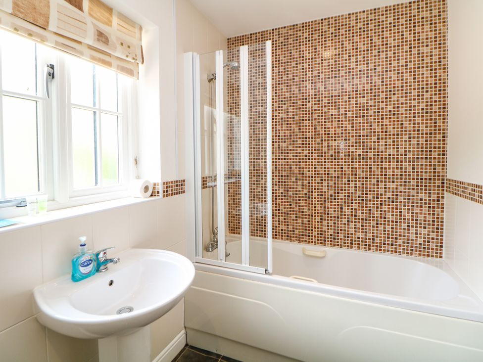 A bathroom with a bathtub and sink at Hartington in Darley Moor near Two Dales