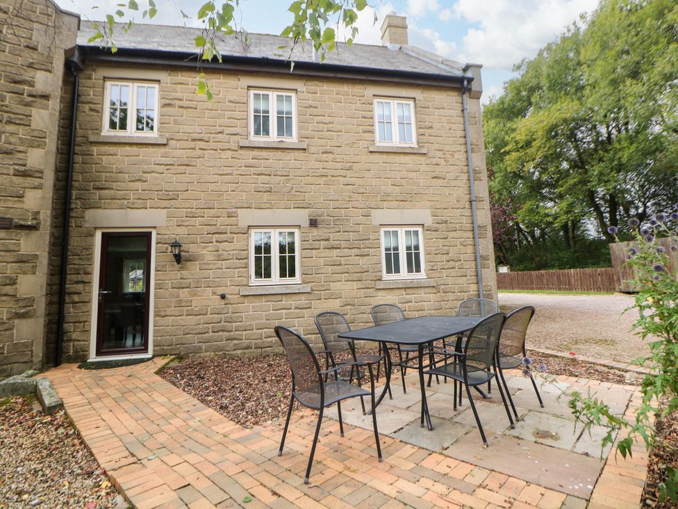 An outdoor seating area with a table and chairs at Hartington in Darley Moor near Two Dales