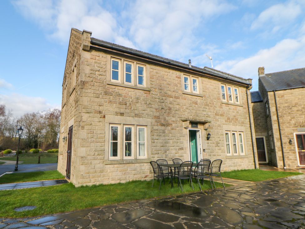 A house with windows and a table with chairs at Riber in Darley Moor near Two Dales