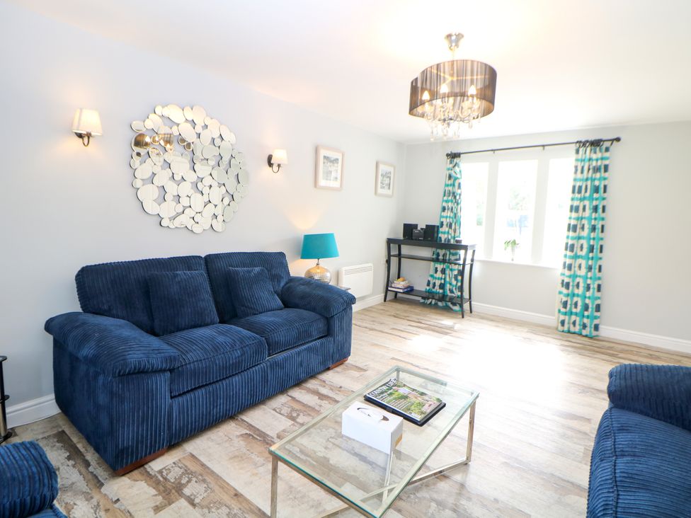A living room with a sofa and coffee table at Riber in Darley Moor near Two Dales