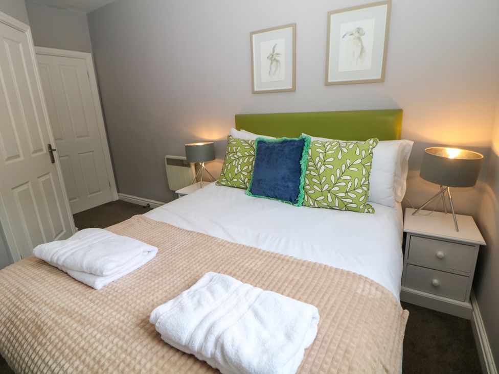 A bedroom with a bed and bedside tables at Riber in Darley Moor near Two Dales