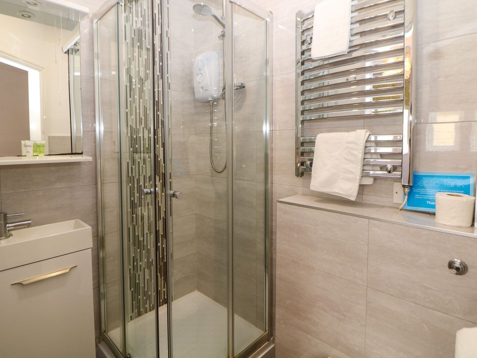 A bathroom with a shower and vanity at Riber in Darley Moor near Two Dales