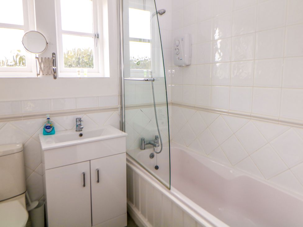 A bathroom with a bathtub and sink at Riber in Darley Moor near Two Dales