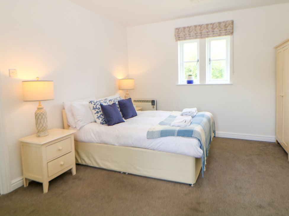 A bedroom with a bed and nightstand at Riber in Darley Moor near Two Dales