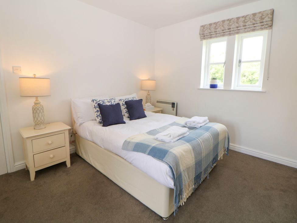 A bedroom with a bed and nightstand at Riber near Darley Moor