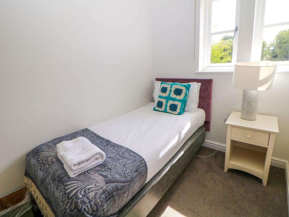 A bedroom with a single bed and a lamp at Riber, Darley Moor near Two Dales
