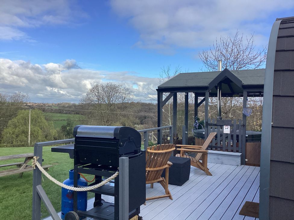 An outdoor area with a grill and seating at Cherry Pod 2, Hookagate near Meole Brace