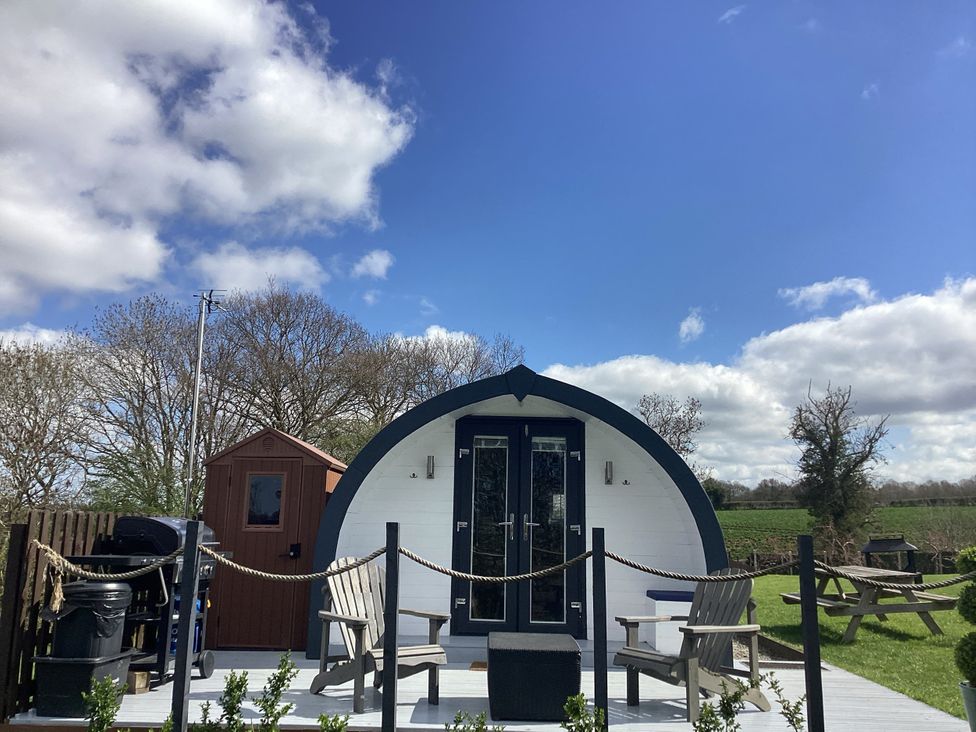 A garden with a pod and seating area at Cherry Pod 2 in Hookagate near Meole Brace