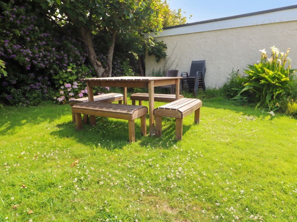 A table and benches in a garden at Porth Ewyn in Trearddur Bay