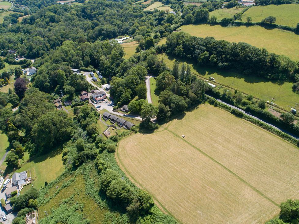 An aerial view of a rural area with fields and houses at 15 Manleigh Park in Combe Martin
