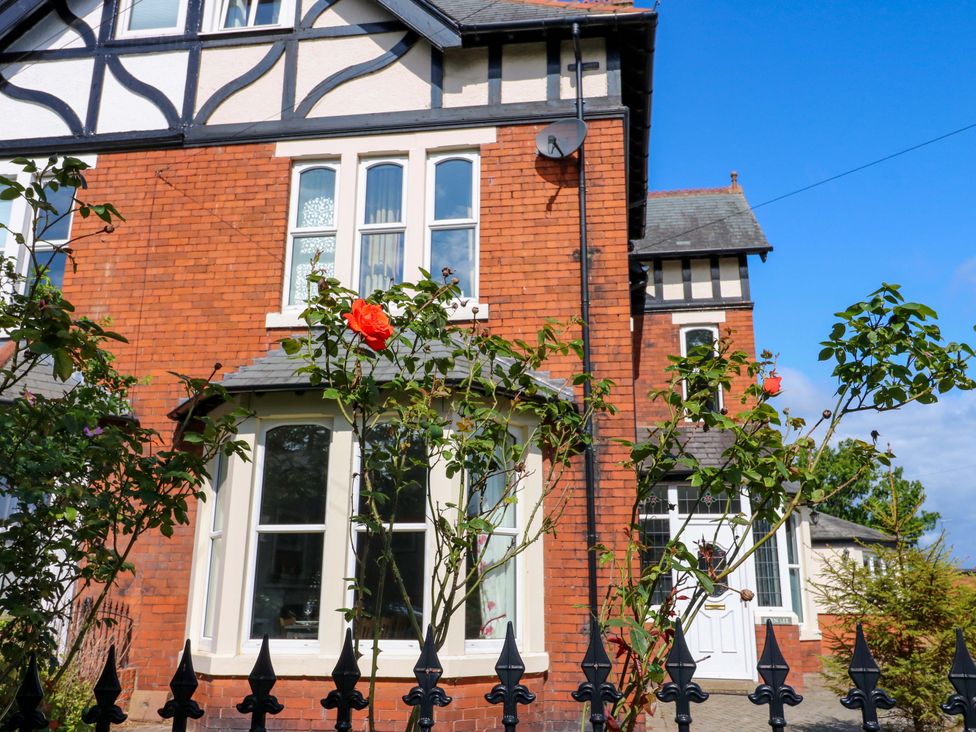 A house with a rose bush in front at Fern Lee in Carlisle