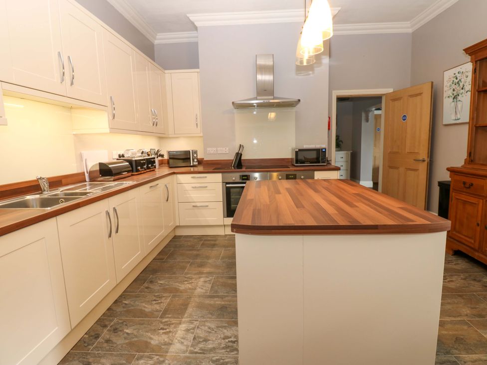 A kitchen with cabinets and appliances at Fern Lee in Carlisle