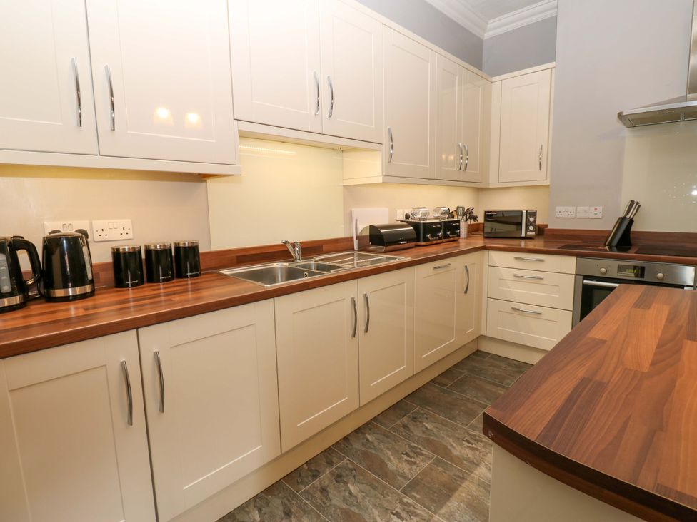 A kitchen with a sink and appliances at Fern Lee in Carlisle