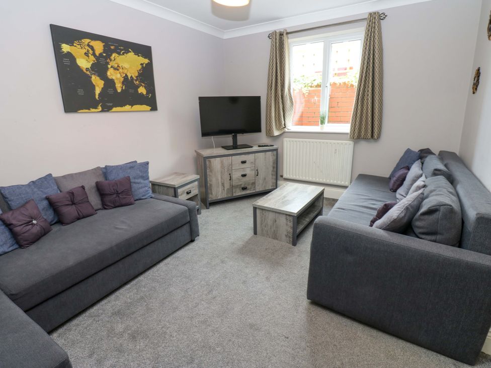 A living room with sofas and a television at Fern Lee in Carlisle