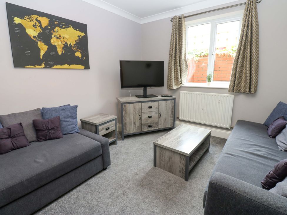 A living room with a television and two sofas at Fern Lee in Carlisle