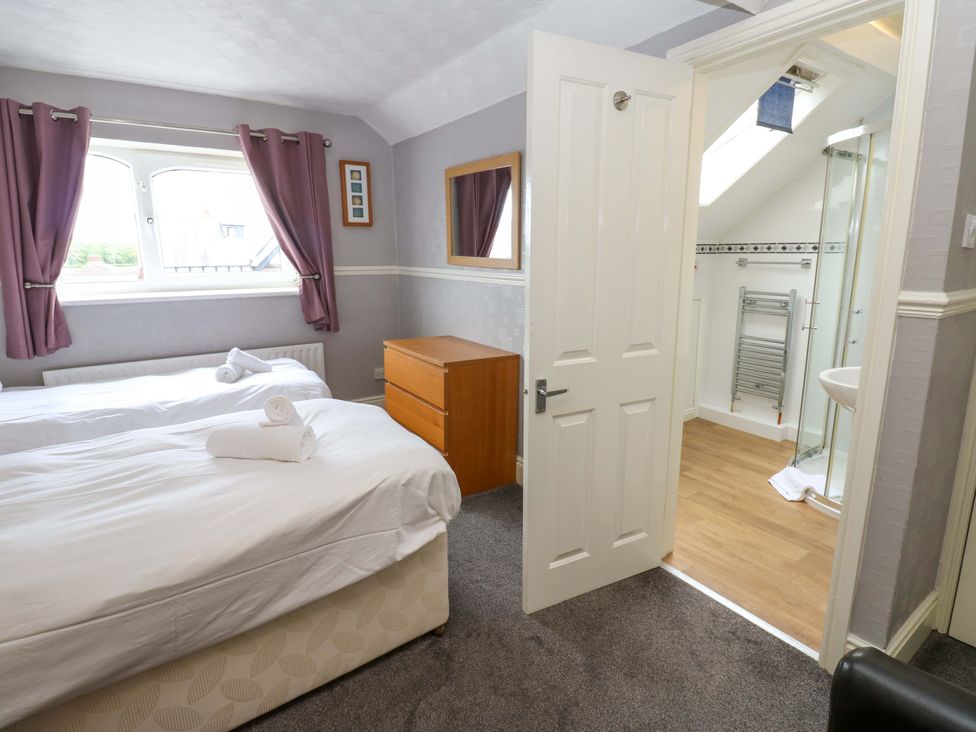 A bedroom with two beds and an ensuite bathroom at Fern Lee in Carlisle