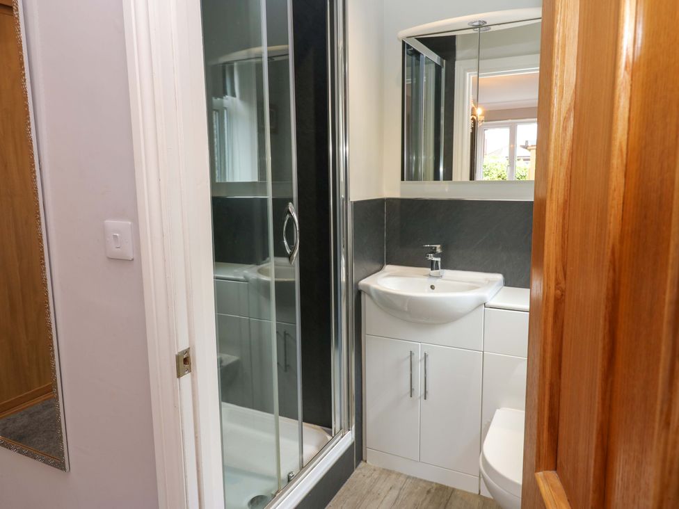 A bathroom with a shower, sink, and toilet at Fern Lee in Carlisle