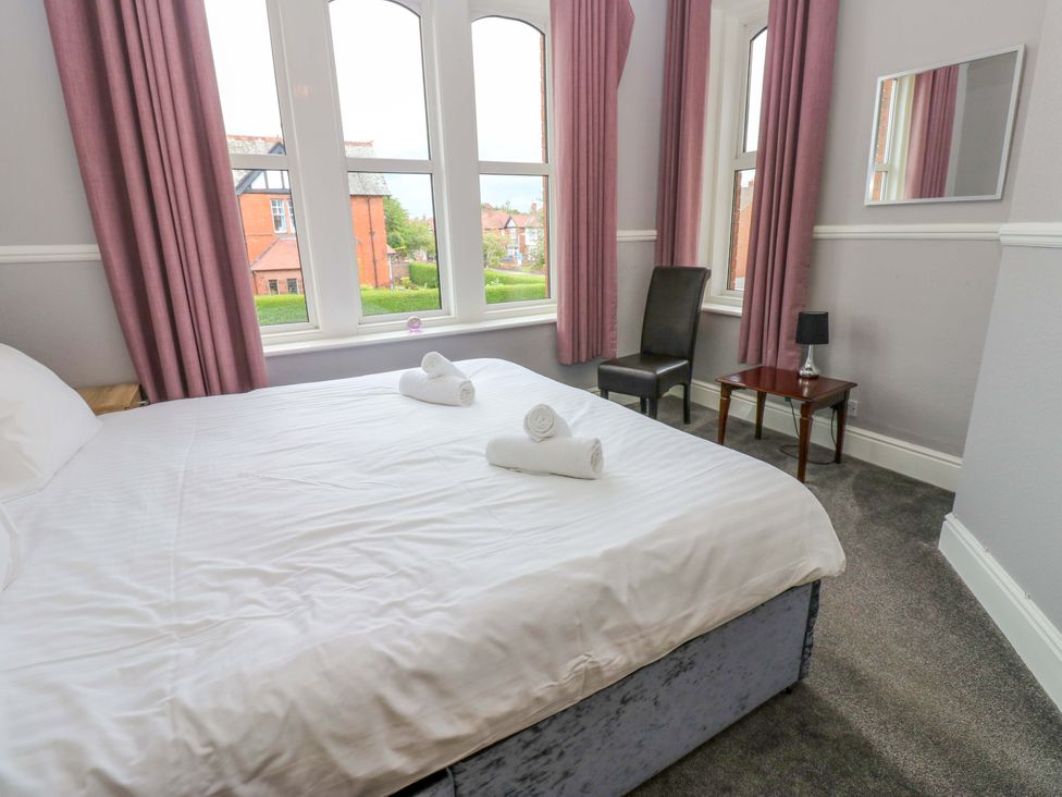 A bedroom with a bed and a chair at Fern Lee in Carlisle