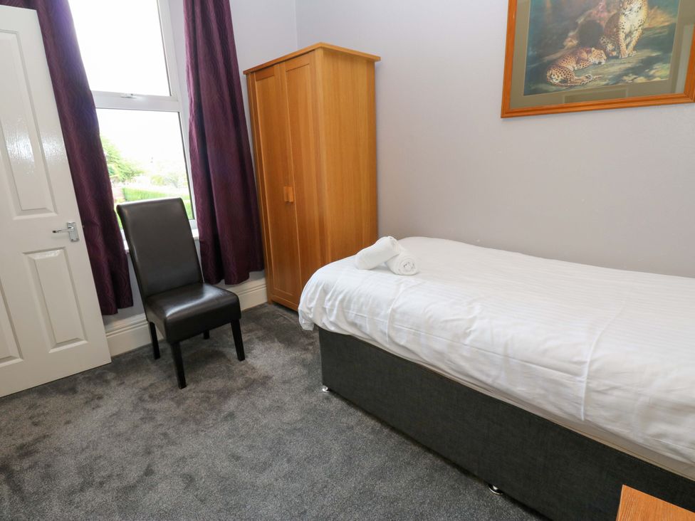 A bedroom with a single bed and wardrobe at Fern Lee in Carlisle