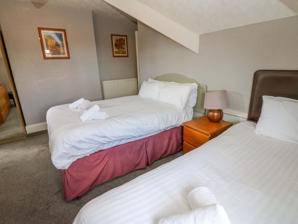 A bedroom with two beds and a bedside table at Fern Lee in Carlisle