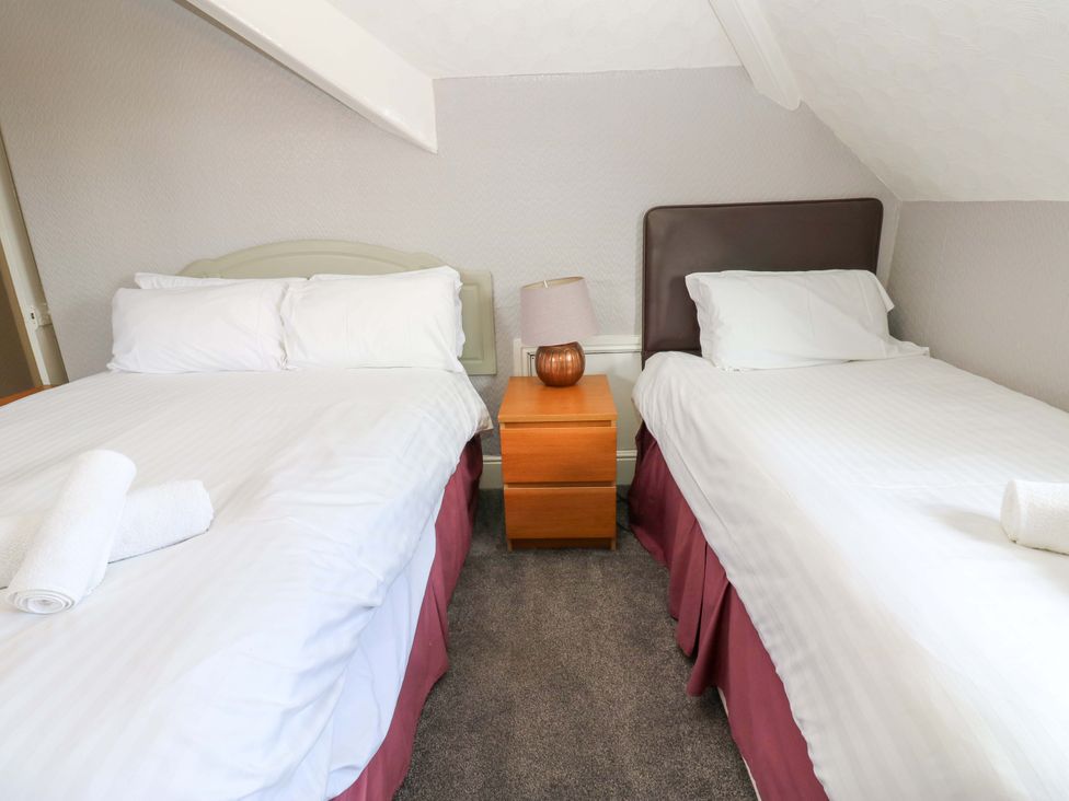 A bedroom with two beds and a bedside table at Fern Lee in Carlisle