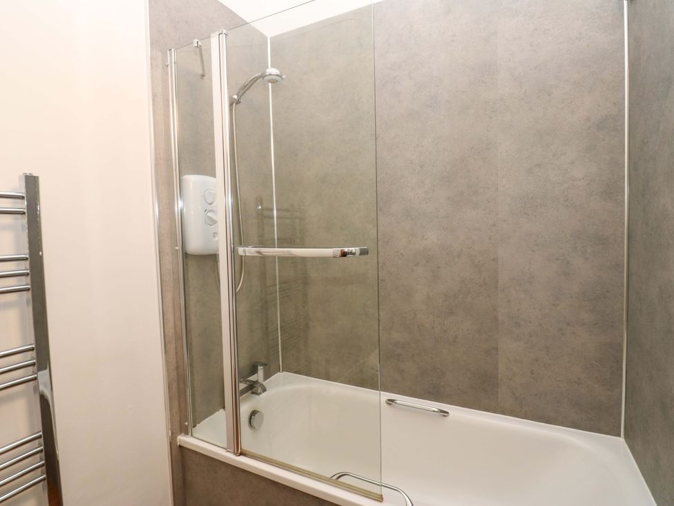 A bathroom with a shower over a bathtub at Fern Lee in Carlisle