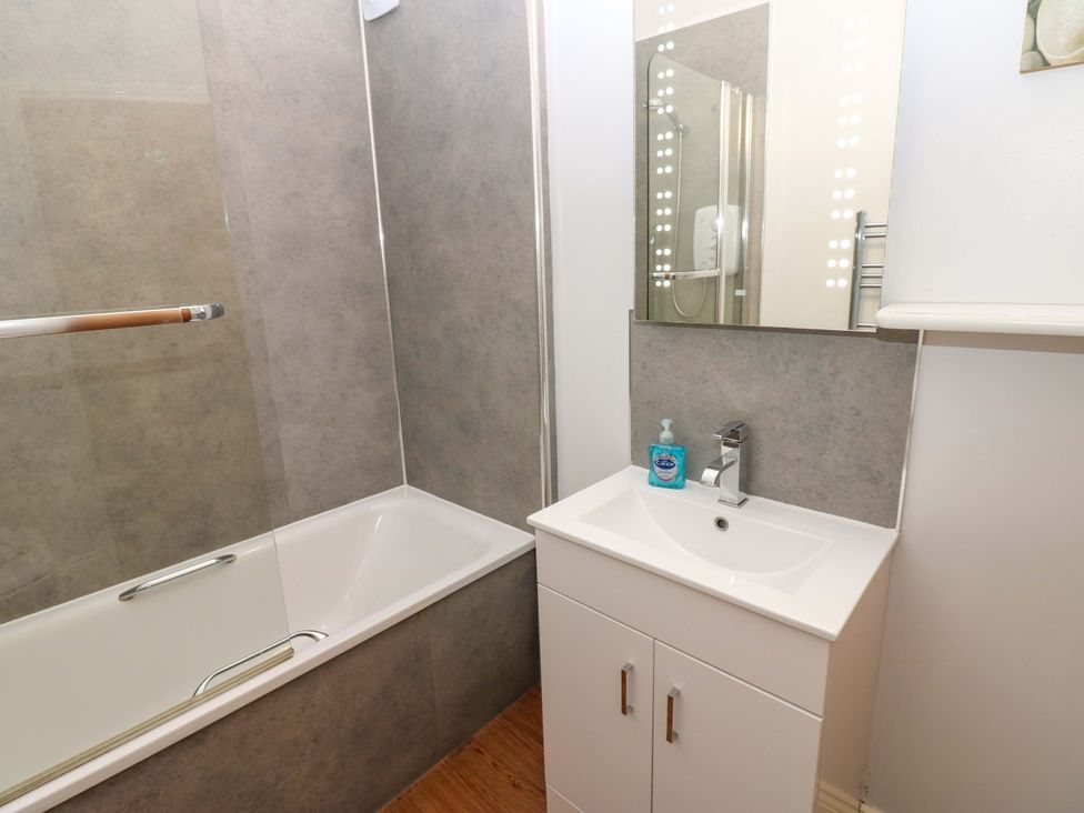 A bathroom with a bathtub and sink at Fern Lee in Carlisle