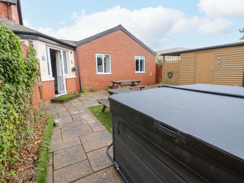 A garden with a hot tub and seating area at Fern Lee in Carlisle