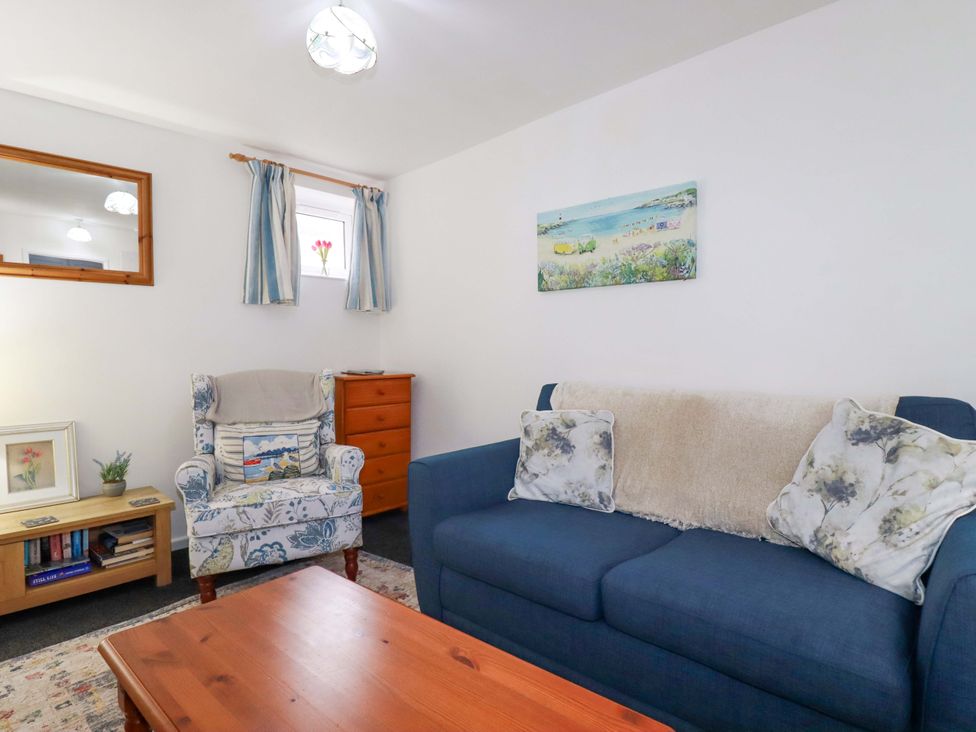 A living room with sofa and armchair at Seaside Apartment in Looe