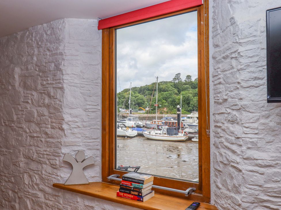 A window showing boats on water at Dolphin Cottage in Brixham