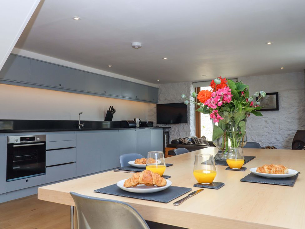 A kitchen with a table set for breakfast at Dolphin Cottage in Brixham