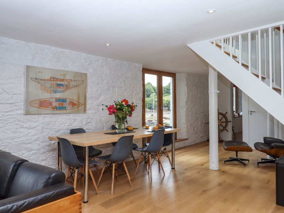 A dining room with a table and chairs at Dolphin Cottage in Brixham