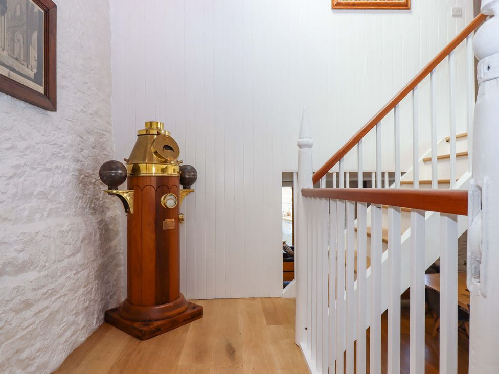 An entryway with a decorative object and staircase at Dolphin Cottage in Brixham