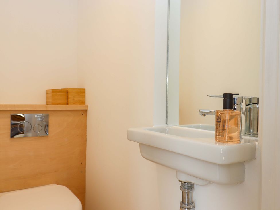 A bathroom with a toilet and sink at Dolphin Cottage in Brixham