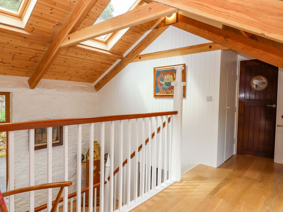 A hallway with wooden stairs and skylights at Dolphin Cottage in Brixham