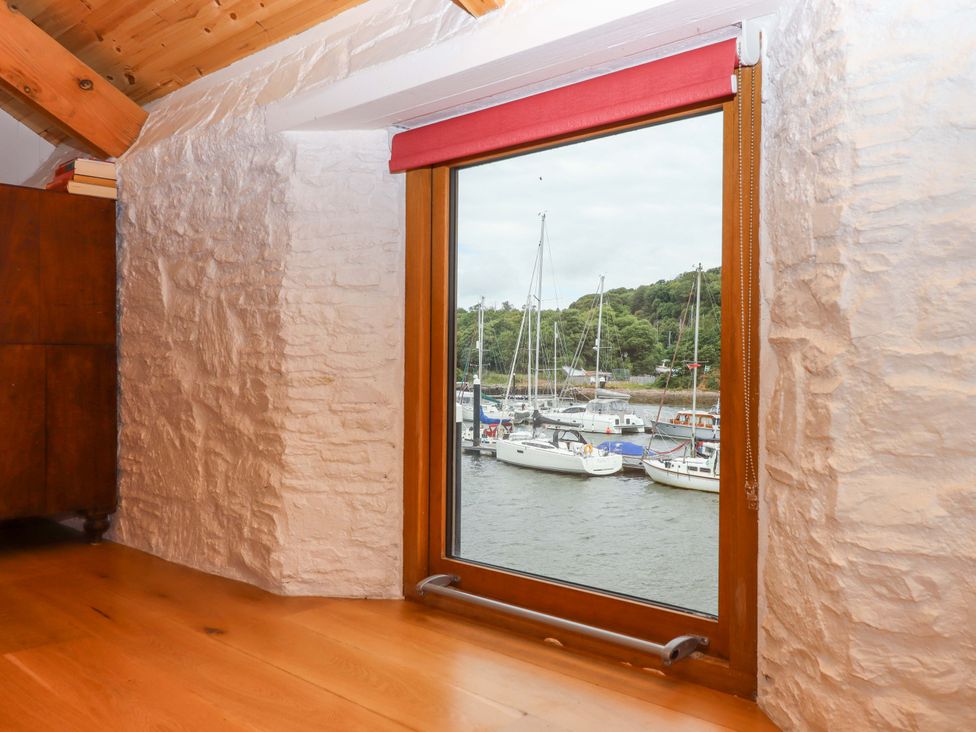 A window showing boats on water at Dolphin Cottage in Brixham