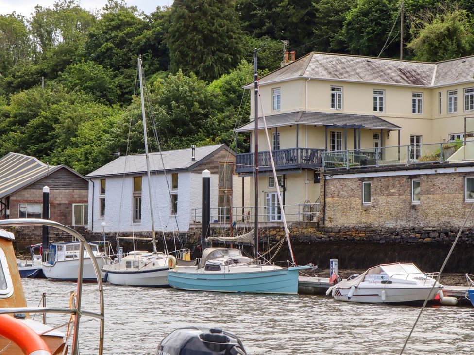 A view of buildings and boats on water at Dolphin Cottage in Brixham