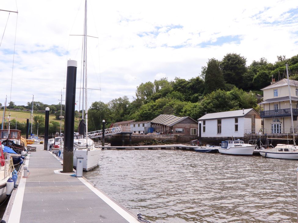 A marina with boats at a dock near buildings at Dolphin Cottage in Brixham