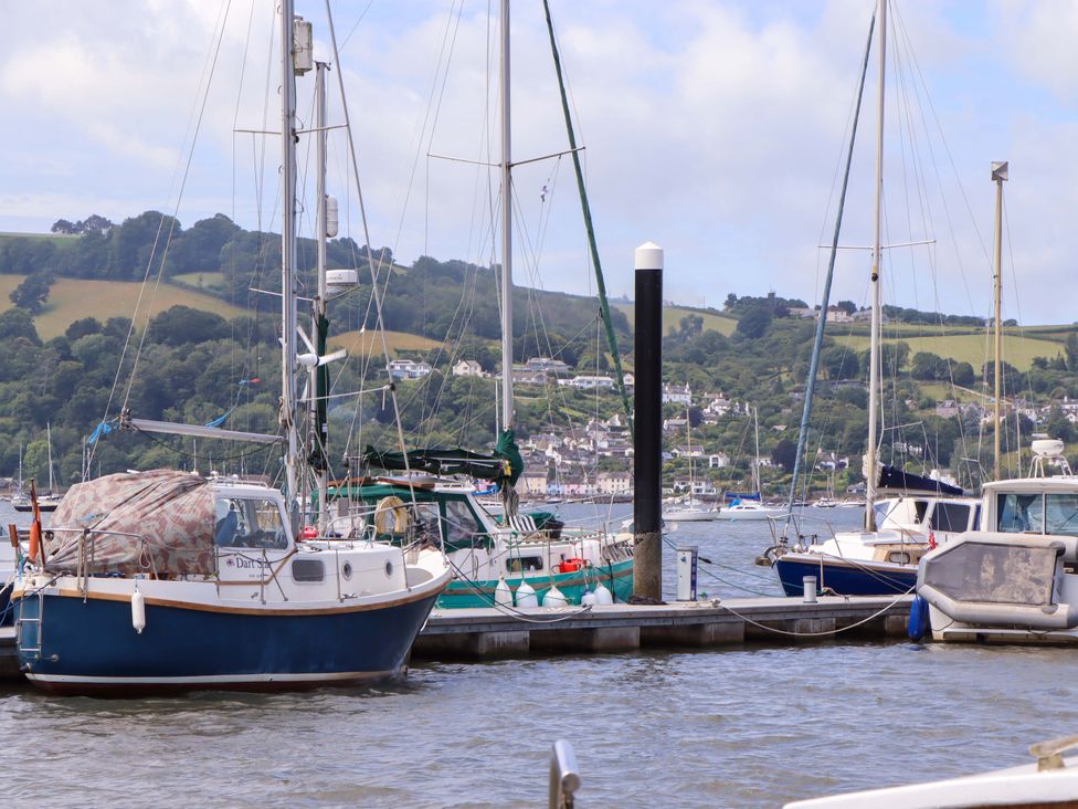 Boats moored at a dock with hills in the background at Dolphin Cottage in Brixham
