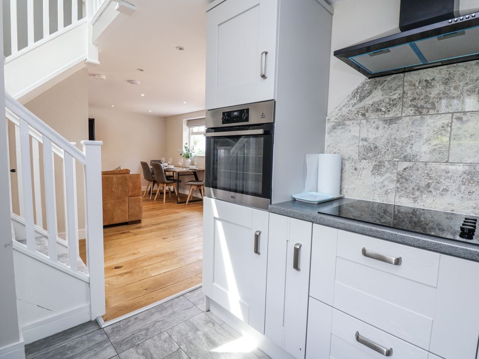 A kitchen with cabinets and an oven at Fern Cottage in Biddulph