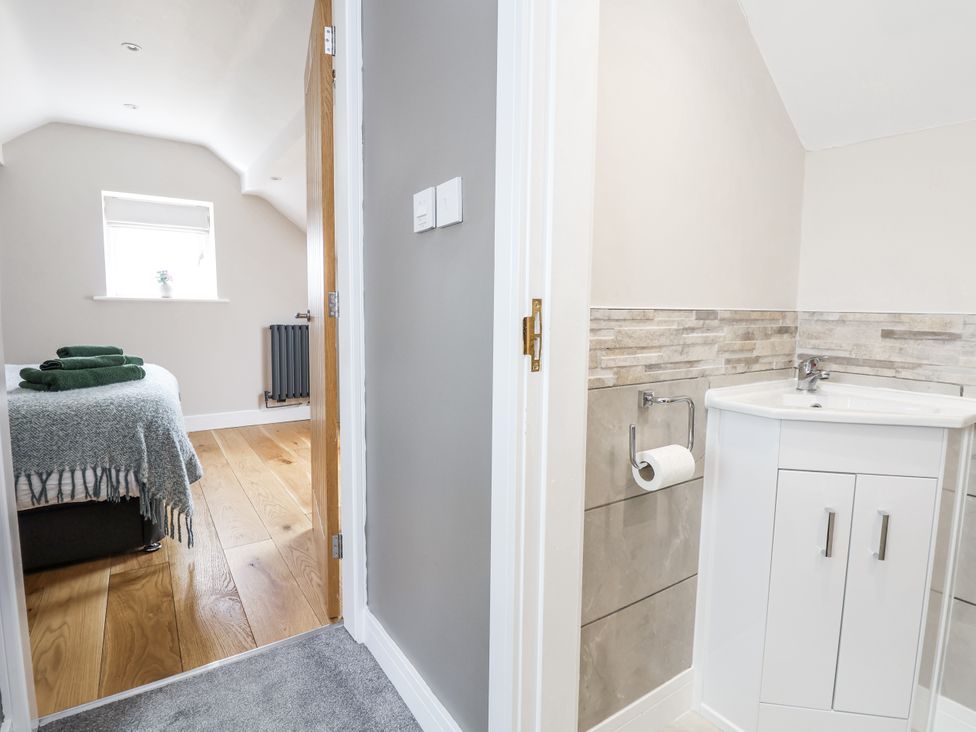 A bathroom with a sink and toilet at Fern Cottage in Biddulph
