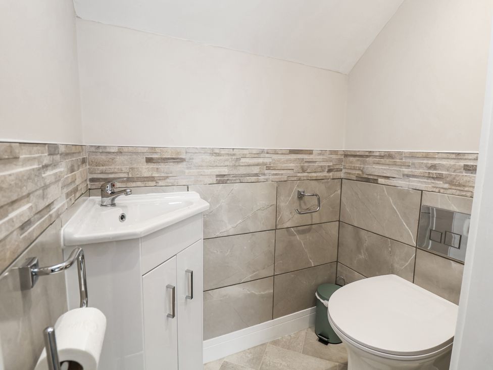 A bathroom with a sink and toilet at Fern Cottage in Biddulph