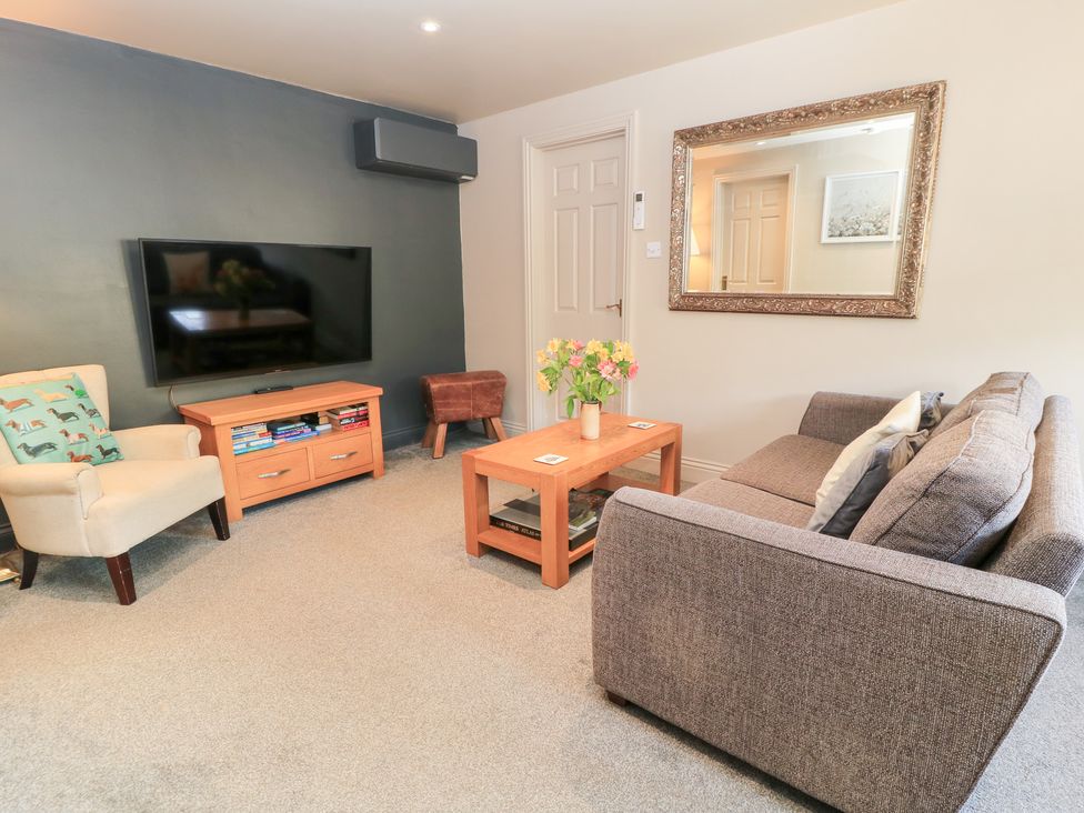 A living room with a sofa and television at Well Cottage Nr Malmesbury