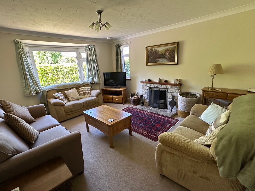 A living room with a coffee table and sofa at Pineside, Sandford, Dorset