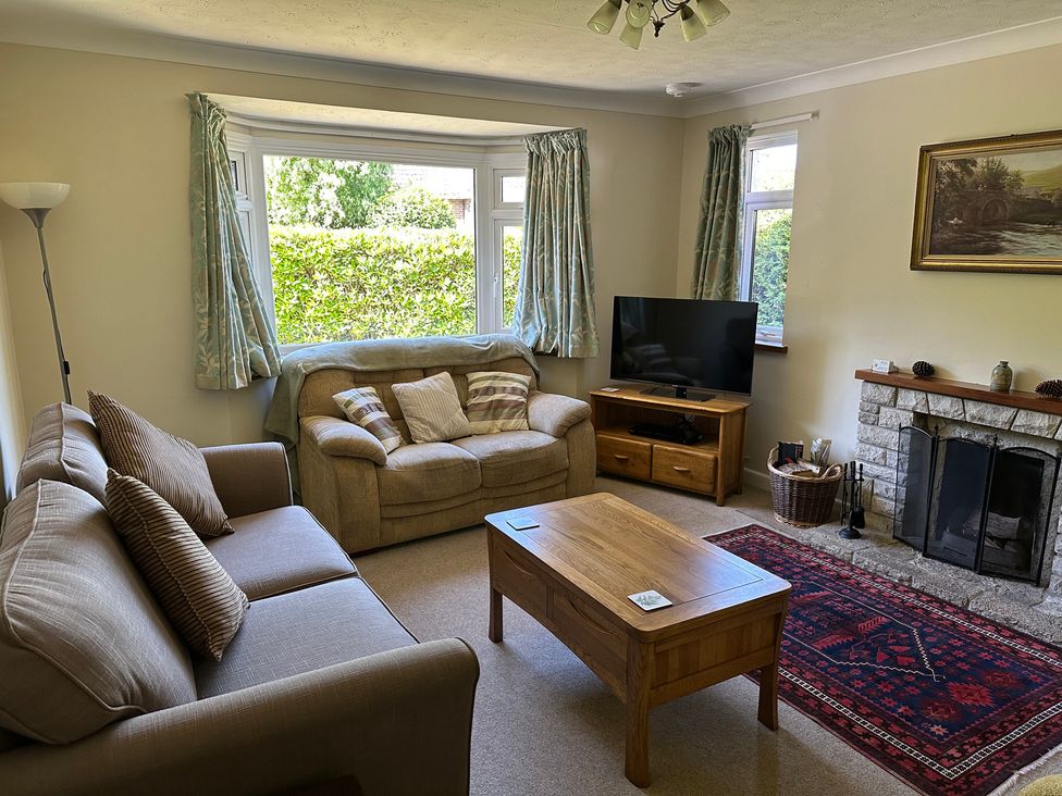A living room with a sofa and television at Pineside Sandford, Dorset